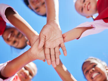 Hands, children and community with girl collaboration on environment cleaning project, happy and excited.